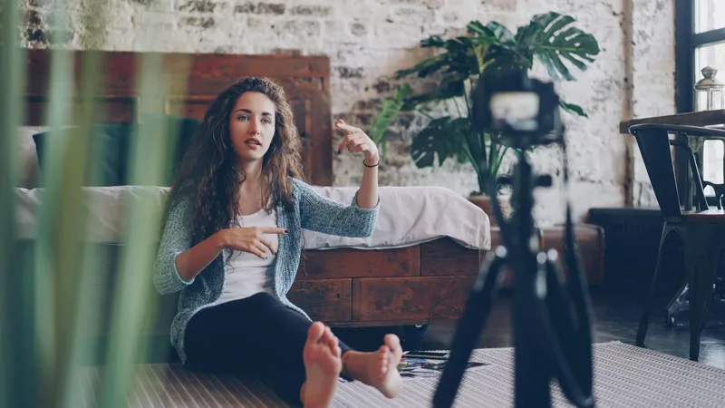 Creator recording a talking-head Reel at a clean desk, speaking directly to camera without heavy production — the real-process approach that builds trust for solo creators