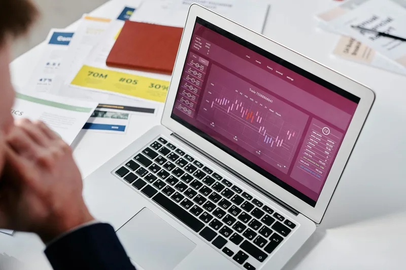 Creator reviewing Instagram Reel analytics on a laptop, displaying reach and watch-through metrics from a recent video post