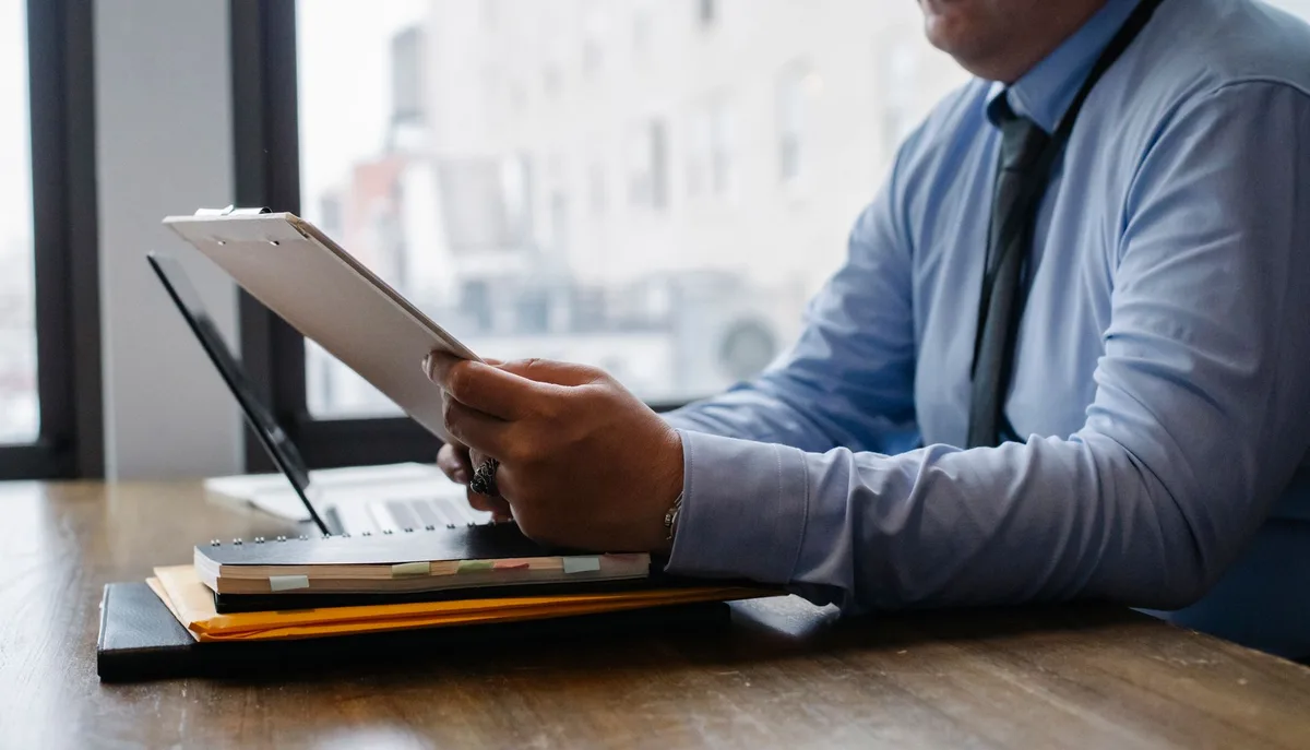 Business professional at a desk reviewing documents and planning their LinkedIn personal brand strategy