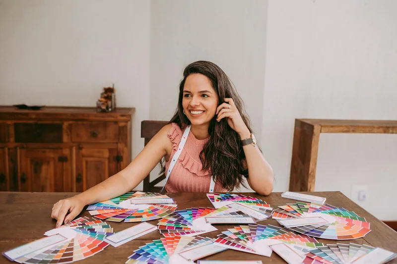 Designer reviewing color palettes at a desk, representing the thumbnail color selection process